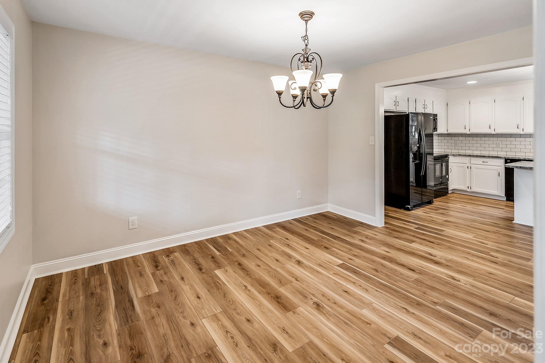 211 Todd Circle Wingate, NC 28174 - Photo 10 of 45 a view of empty room with wooden floor and window