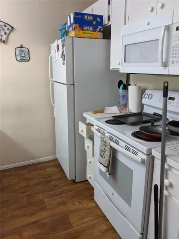 a white stove top oven sitting inside of a kitchen