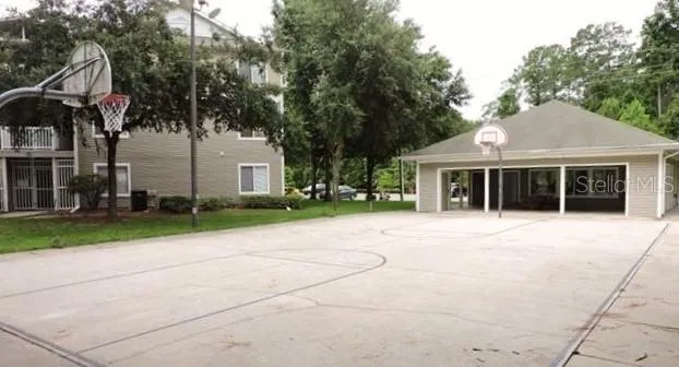 a front view of a house with a garden and trees