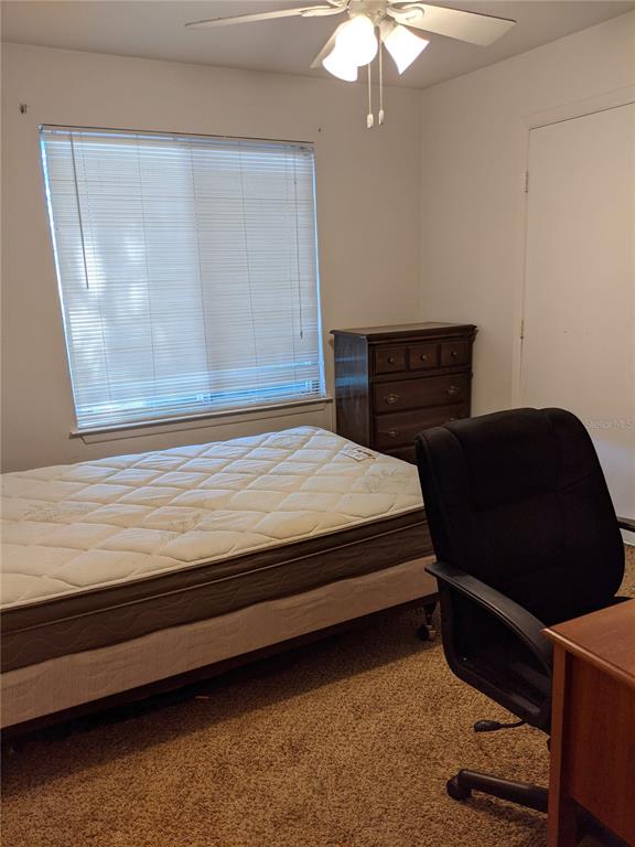 4000 Southwest 23rd Street, Unit 5106 Gainesville, FL 32608 - Photo 6 of 9 a bedroom with a bed and a dresser