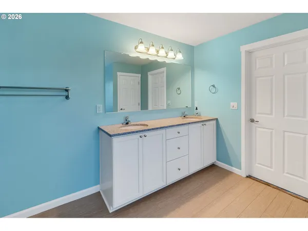 a spacious bathroom with a double vanity sink and a mirror