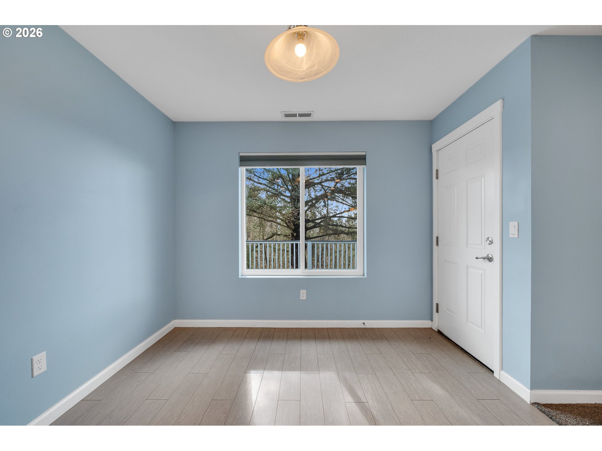 10360 Skyview Road Tillamook, OR 97141 - Photo 22 of 42 a view of an empty room with a window and wooden floor