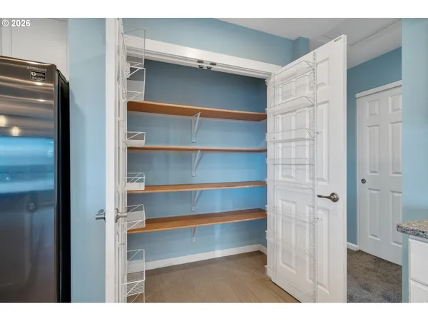 a view of walk in closet with empty racks