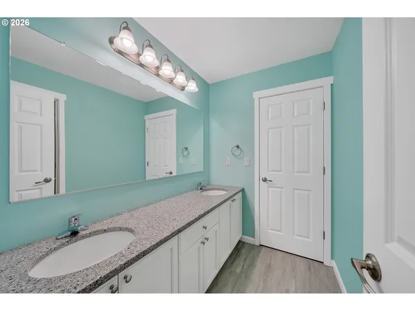 a bathroom with a granite countertop sink mirror and a