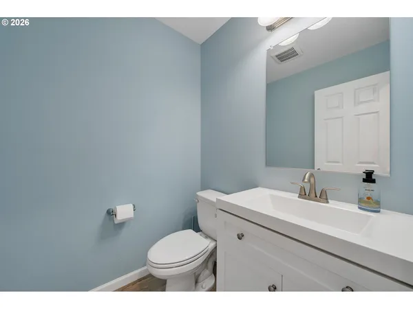 a bathroom with a sink a toilet and mirror