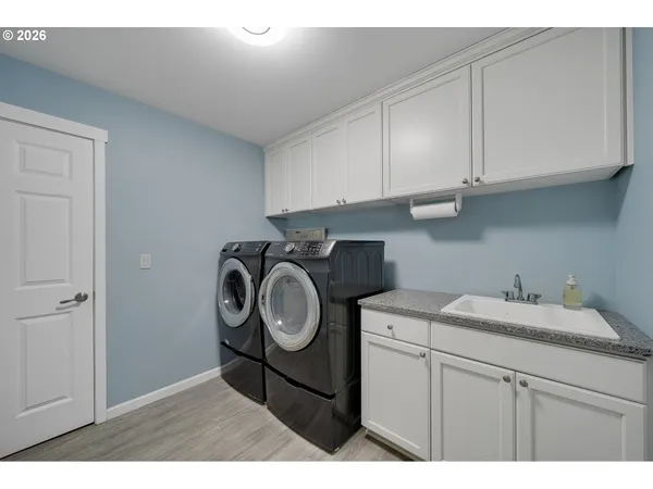 a utility room with sink dryer and washer