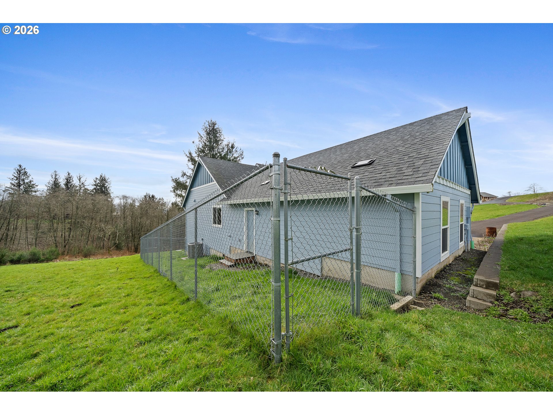 10360 Skyview Road Tillamook, OR 97141 - Photo 41 of 42 a backyard of a house with plants and a yard