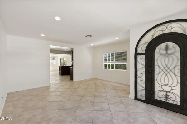 a view of an empty room with a fireplace and a window