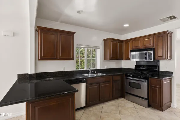 a kitchen with a sink stove and microwave