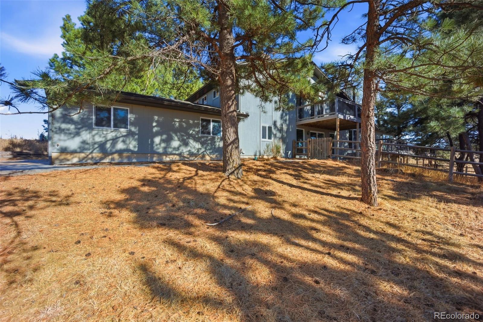 a front view of a house with a yard and covered with snow