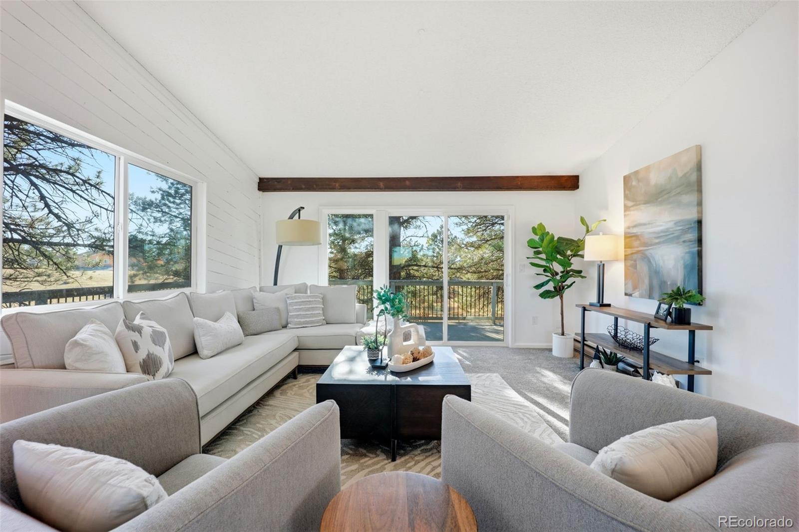 9212 East Tanglewood Road Franktown, CO 80116 - Photo 11 of 50 a living room with furniture and a large window