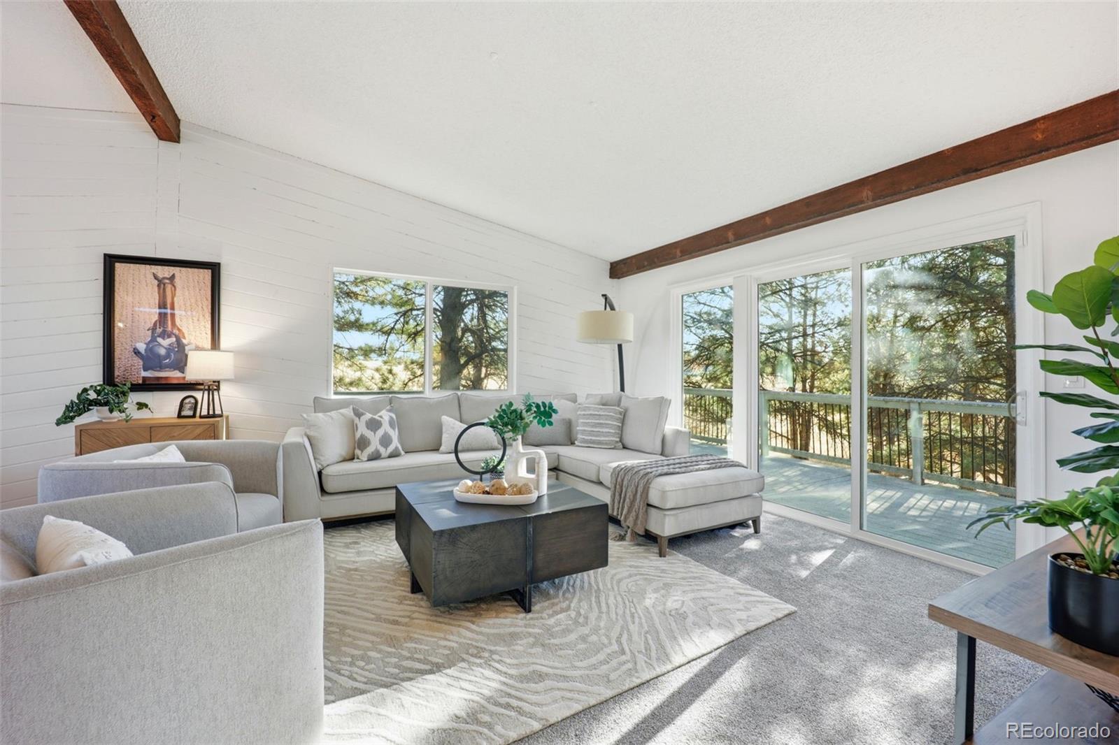 9212 East Tanglewood Road Franktown, CO 80116 - Photo 12 of 50 a living room with furniture and a large window