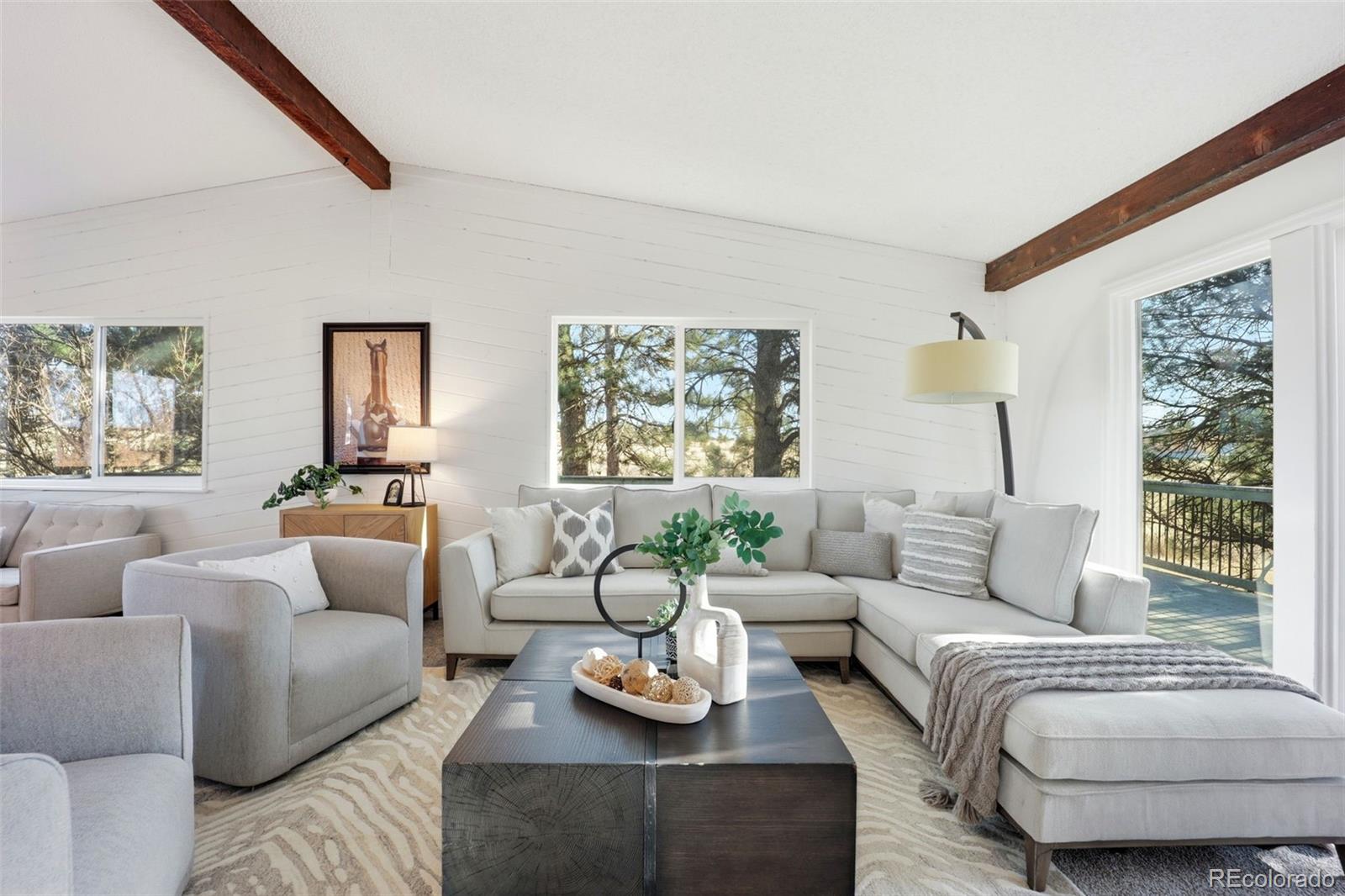 9212 East Tanglewood Road Franktown, CO 80116 - Photo 13 of 50 a living room with furniture and a large window
