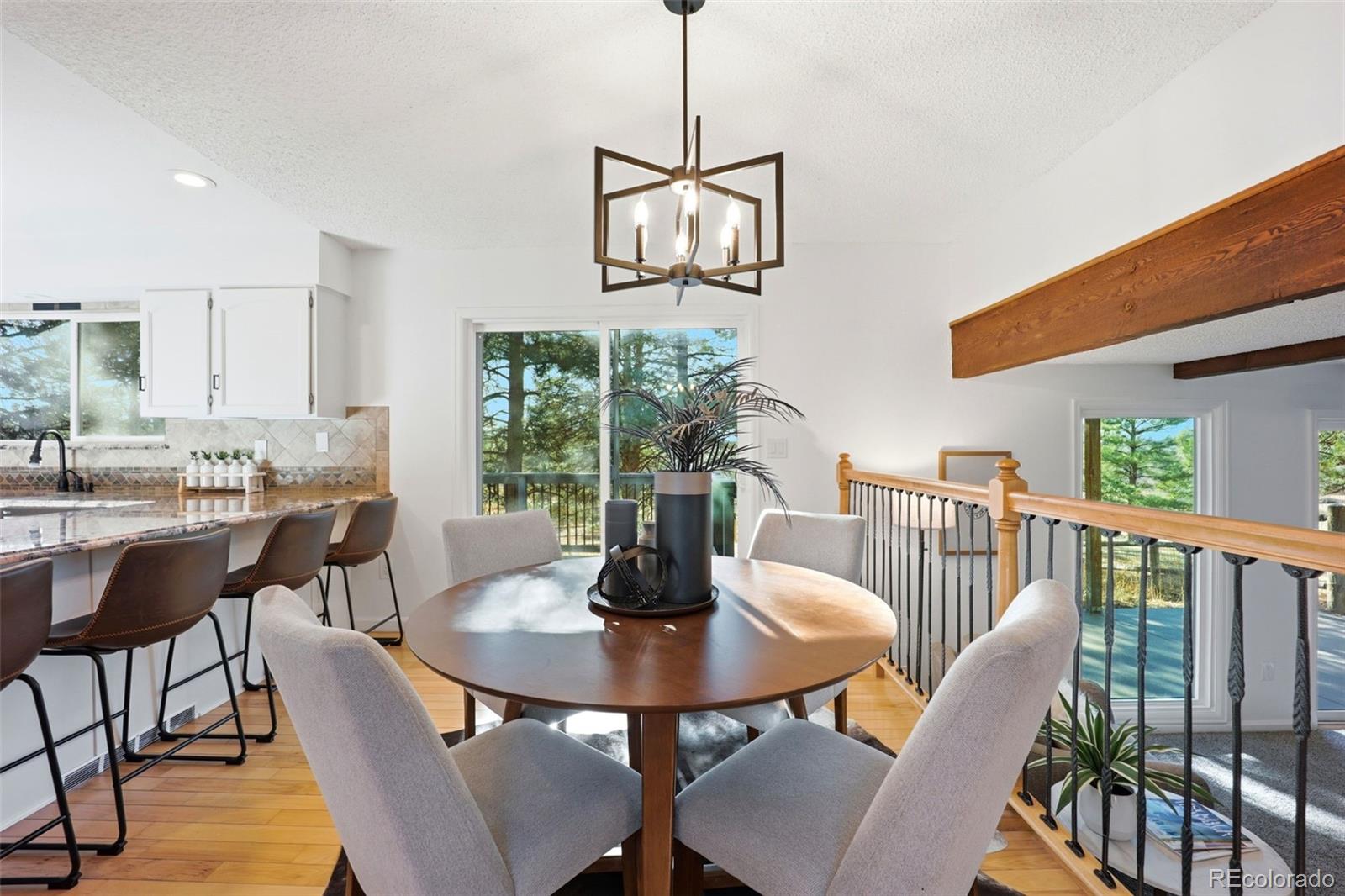 9212 East Tanglewood Road Franktown, CO 80116 - Photo 15 of 50 a view of a dining room with furniture window and outside view