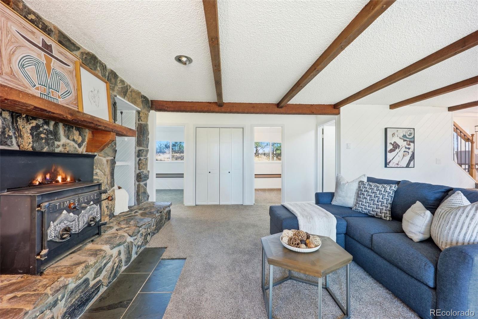 9212 East Tanglewood Road Franktown, CO 80116 - Photo 25 of 50 a living room with furniture and a wooden floor