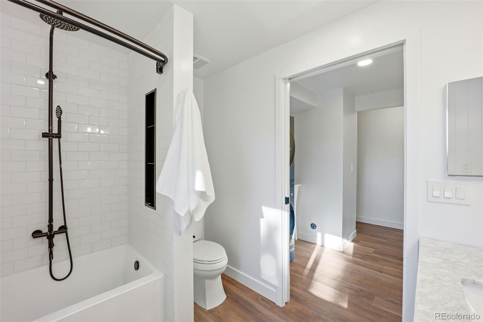 9212 East Tanglewood Road Franktown, CO 80116 - Photo 30 of 50 a bathroom with a shower toilet and sink