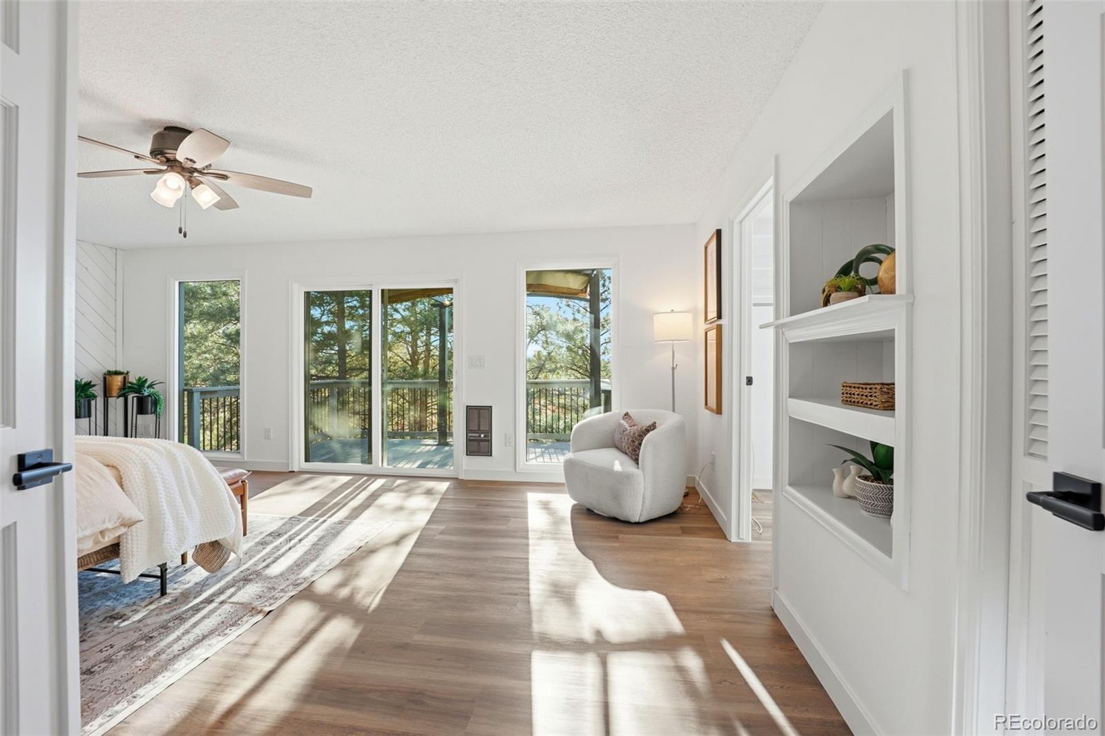 9212 East Tanglewood Road Franktown, CO 80116 - Photo 34 of 50 a spacious bedroom with a bed and large window