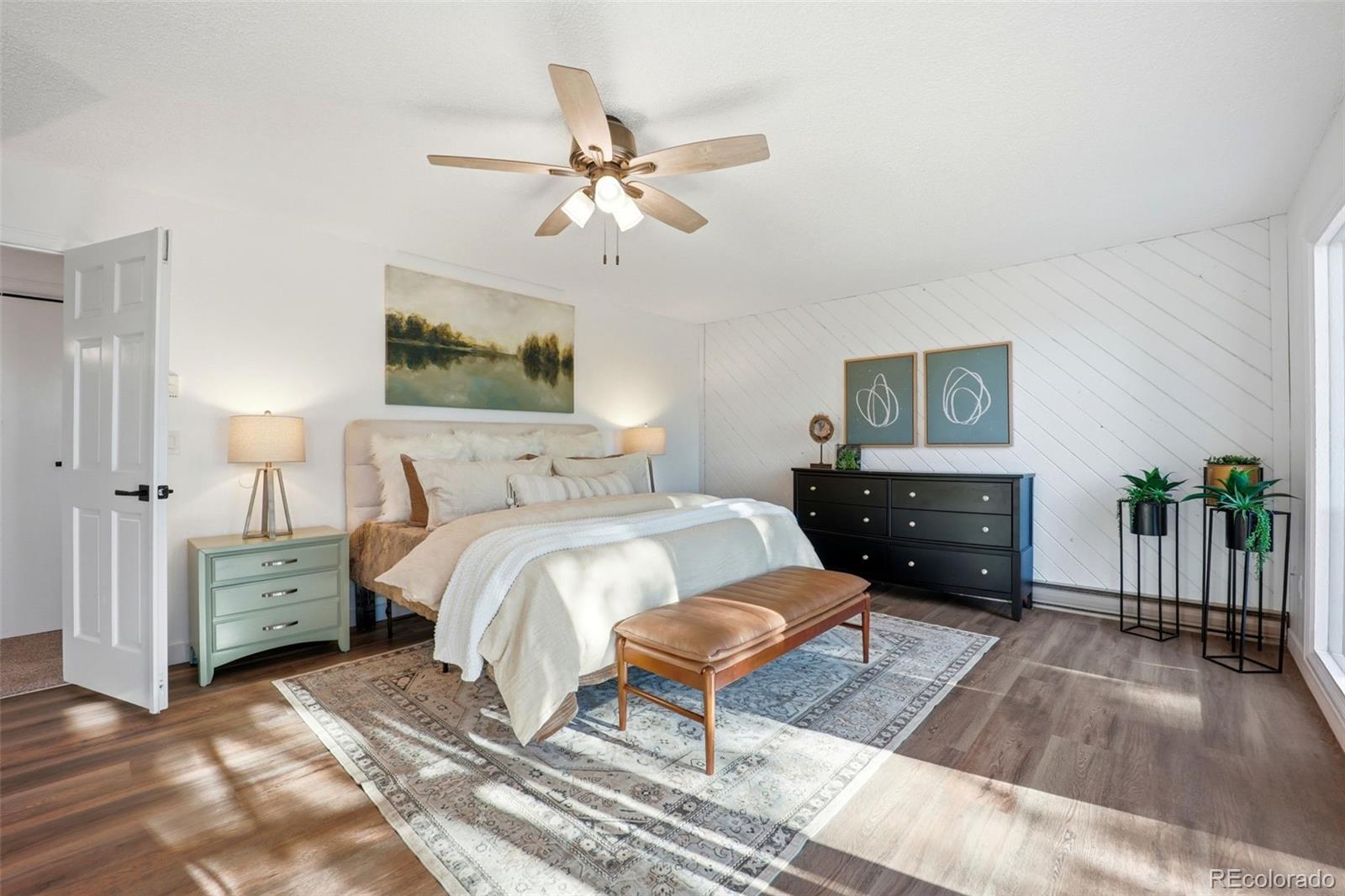 9212 East Tanglewood Road Franktown, CO 80116 - Photo 35 of 50 a bedroom with a bed and a chandelier
