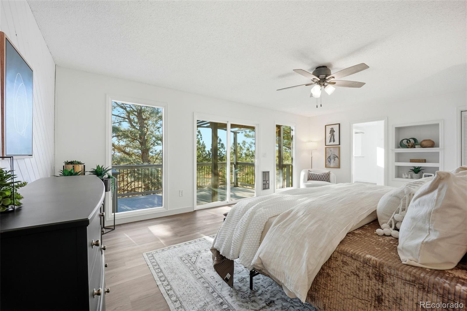 9212 East Tanglewood Road Franktown, CO 80116 - Photo 36 of 50 a spacious bedroom with a large bed and a window