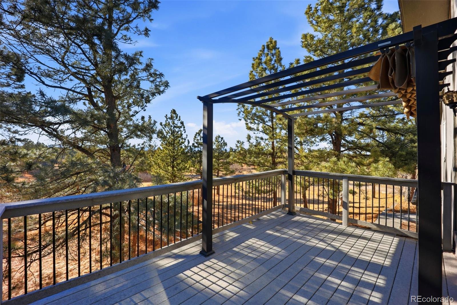 9212 East Tanglewood Road Franktown, CO 80116 - Photo 39 of 50 a view of balcony with wooden floor and seating space