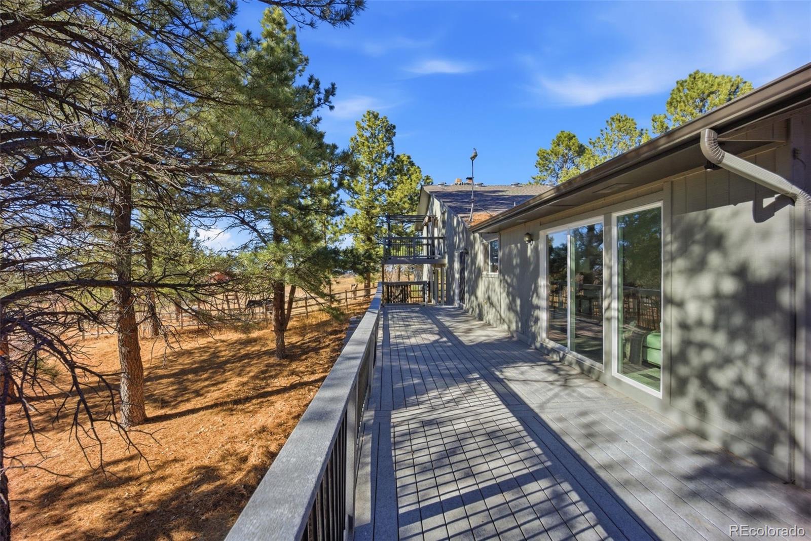 9212 East Tanglewood Road Franktown, CO 80116 - Photo 47 of 50 a view of a balcony with wooden floor and fence