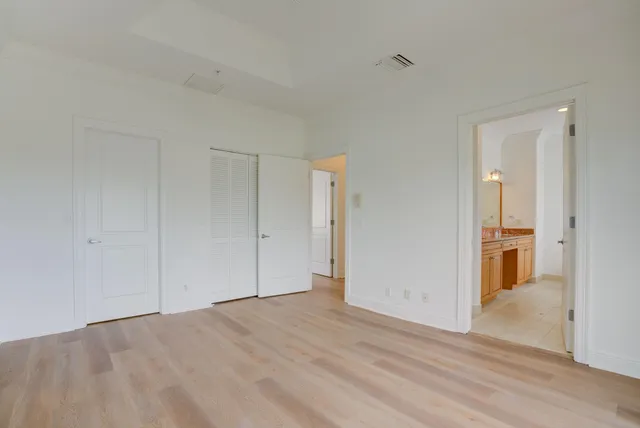 a bathroom with a granite countertop bathtub sink vanity and mirror