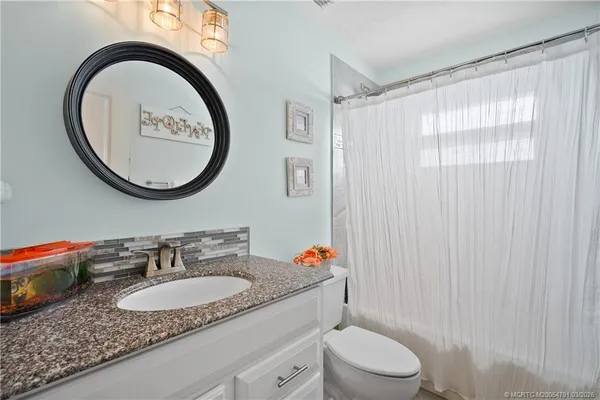 a bathroom with a shower and a sink