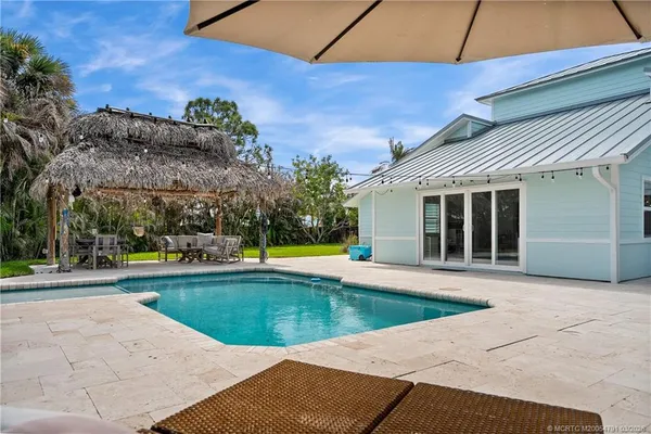 a view of a house with a yard and sitting area