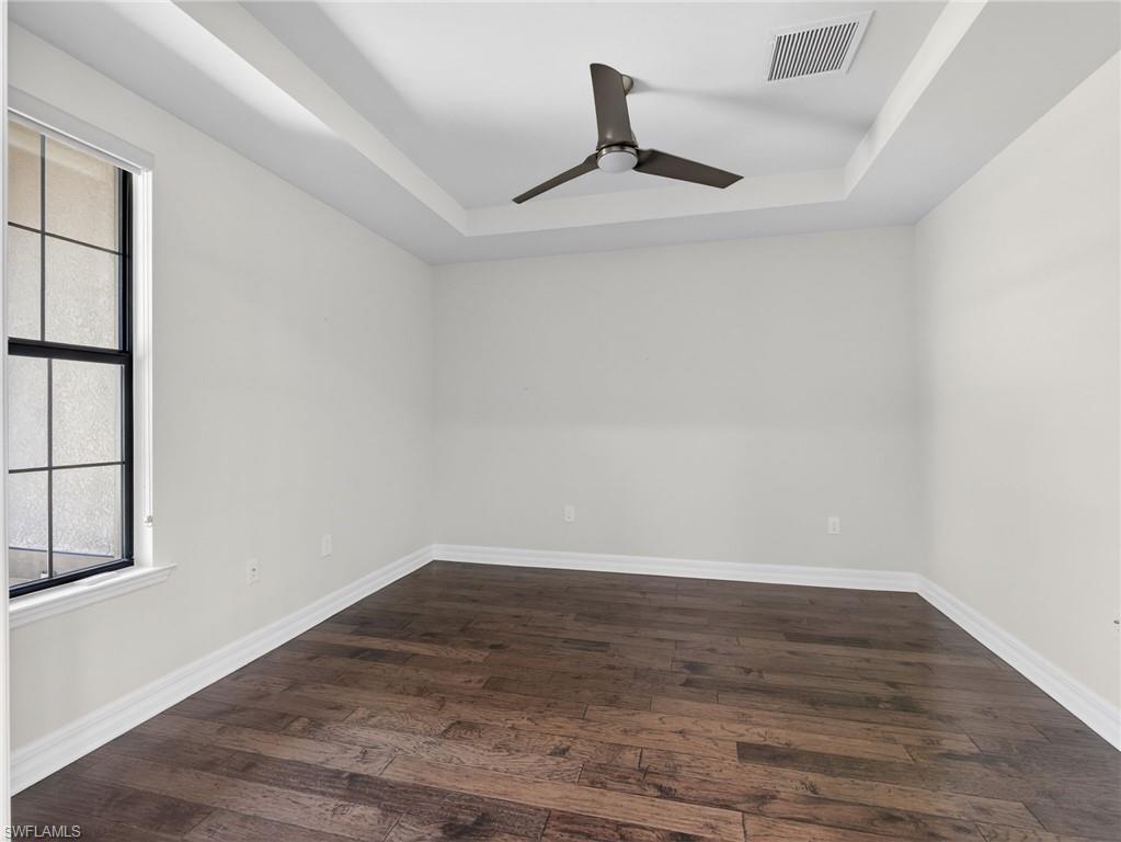 6124 Victory Drive Ave Maria, FL 34142 - Photo 34 of 50 a view of an empty room with wooden floor and a window