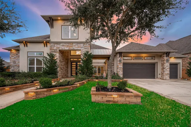 a front view of a house with a yard and garage