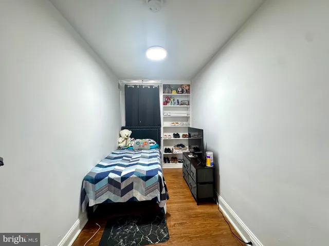 a bedroom with a bed and a tv