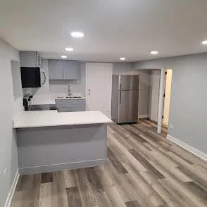 a large white kitchen with a sink