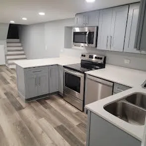 a kitchen with a sink cabinets and stainless steel appliances