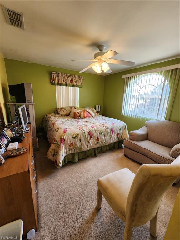 21524 Windham Run Estero, FL 33928 - Photo 14 of 18 a bedroom with bed and window