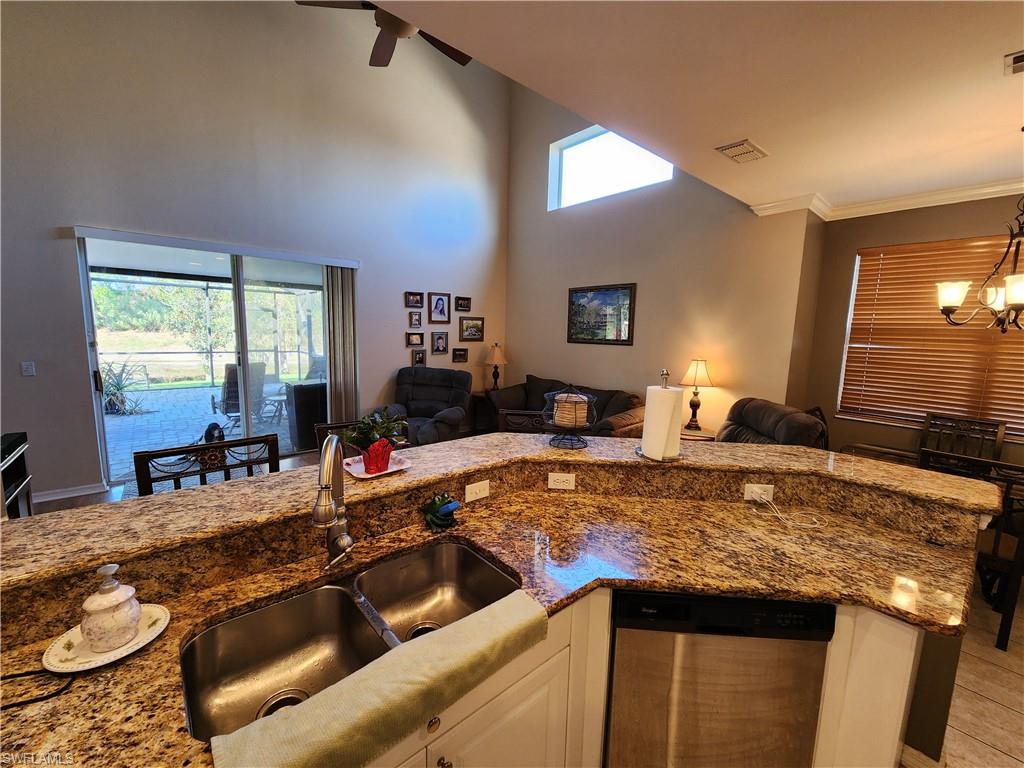 21524 Windham Run Estero, FL 33928 - Photo 17 of 18 a kitchen with stainless steel appliances granite countertop a sink and a stove