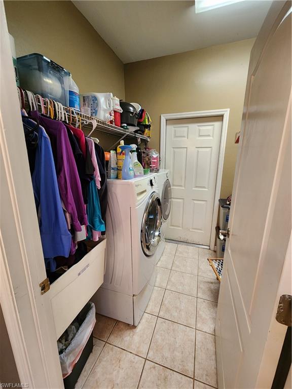 21524 Windham Run Estero, FL 33928 - Photo 18 of 18 a view of walk in closet with clothes and shoes