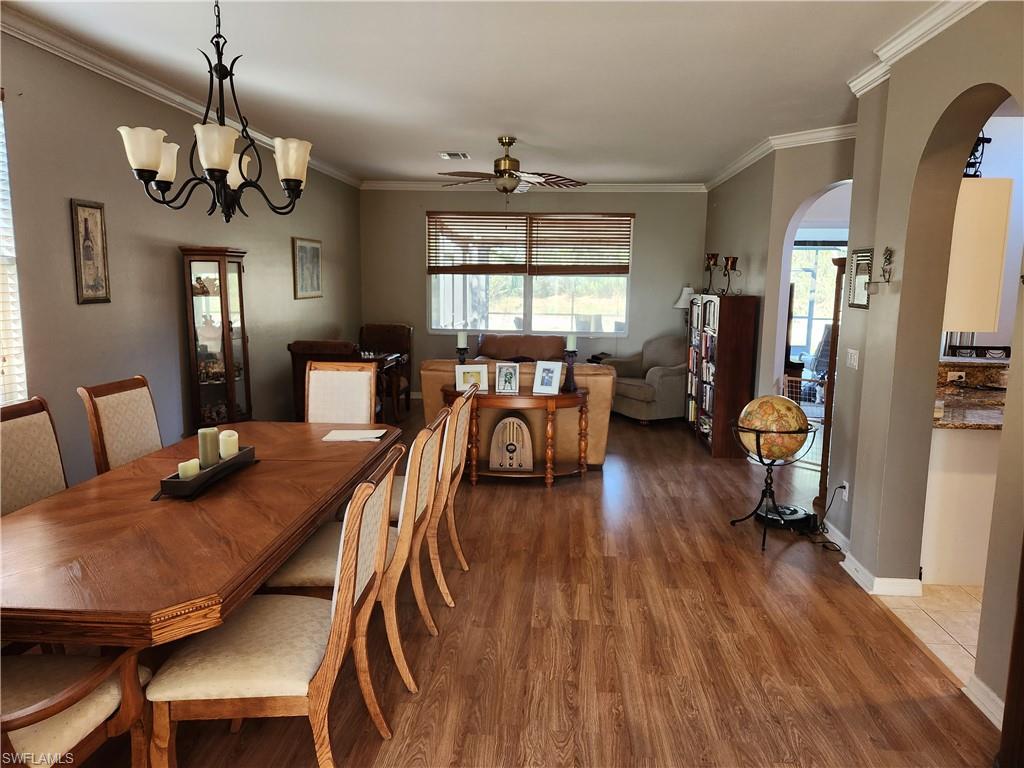21524 Windham Run Estero, FL 33928 - Photo 3 of 18 a view of a dining room with furniture window and wooden floor