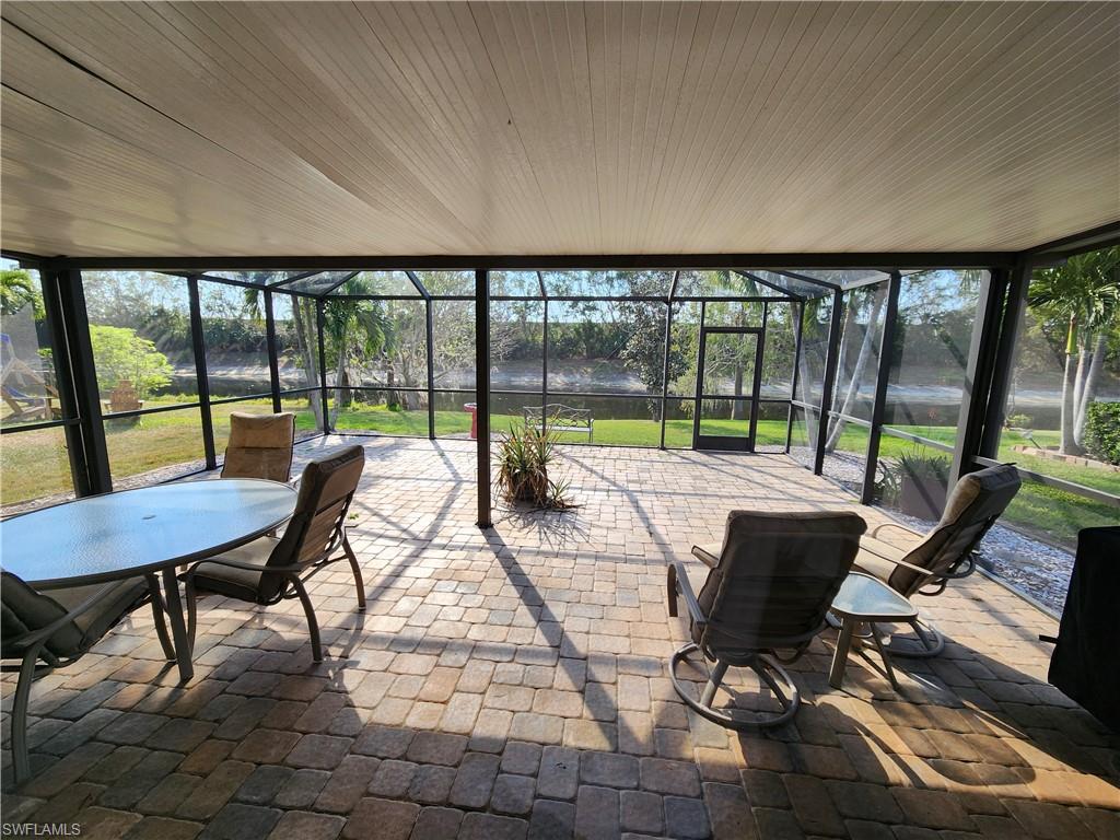 21524 Windham Run Estero, FL 33928 - Photo 8 of 18 a view of a patio with a dining table and chairs