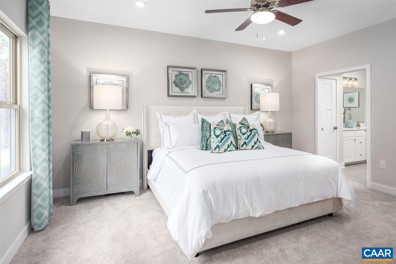 363 Winding Road Keswick, VA 22947 - Photo 13 of 24 a bedroom with a bed and a chandelier