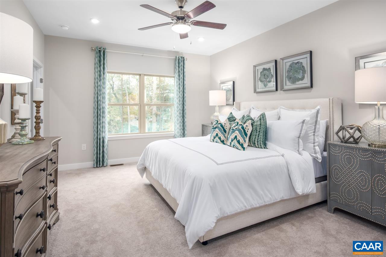 363 Winding Road Keswick, VA 22947 - Photo 14 of 24 a bedroom with a large bed and a chandelier