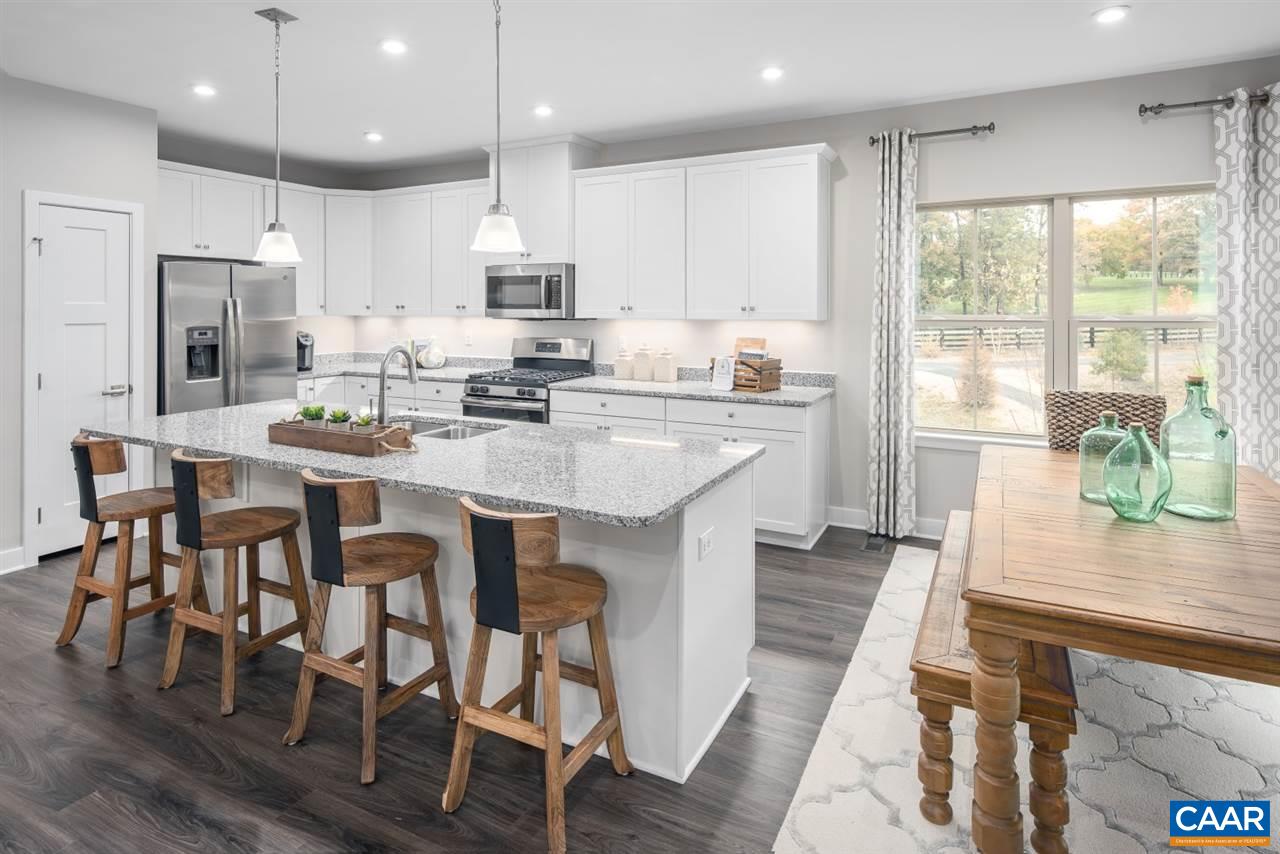 363 Winding Road Keswick, VA 22947 - Photo 7 of 24 a kitchen with stainless steel appliances kitchen island granite countertop a table chairs sink and cabinets