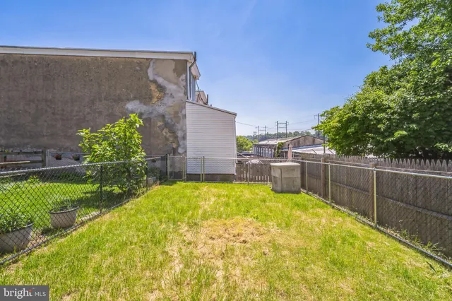 a swimming pool with outdoor seating and yard