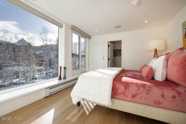 a bedroom with a bed and a painting on the wall