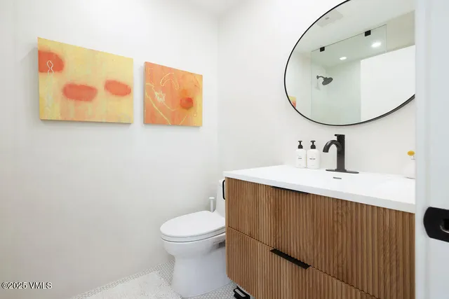 a living room with furniture a chandelier and a table
