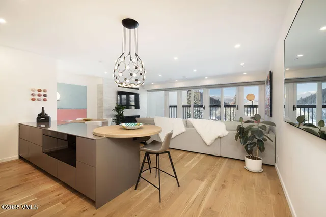 a kitchen with kitchen island a sink table and chairs