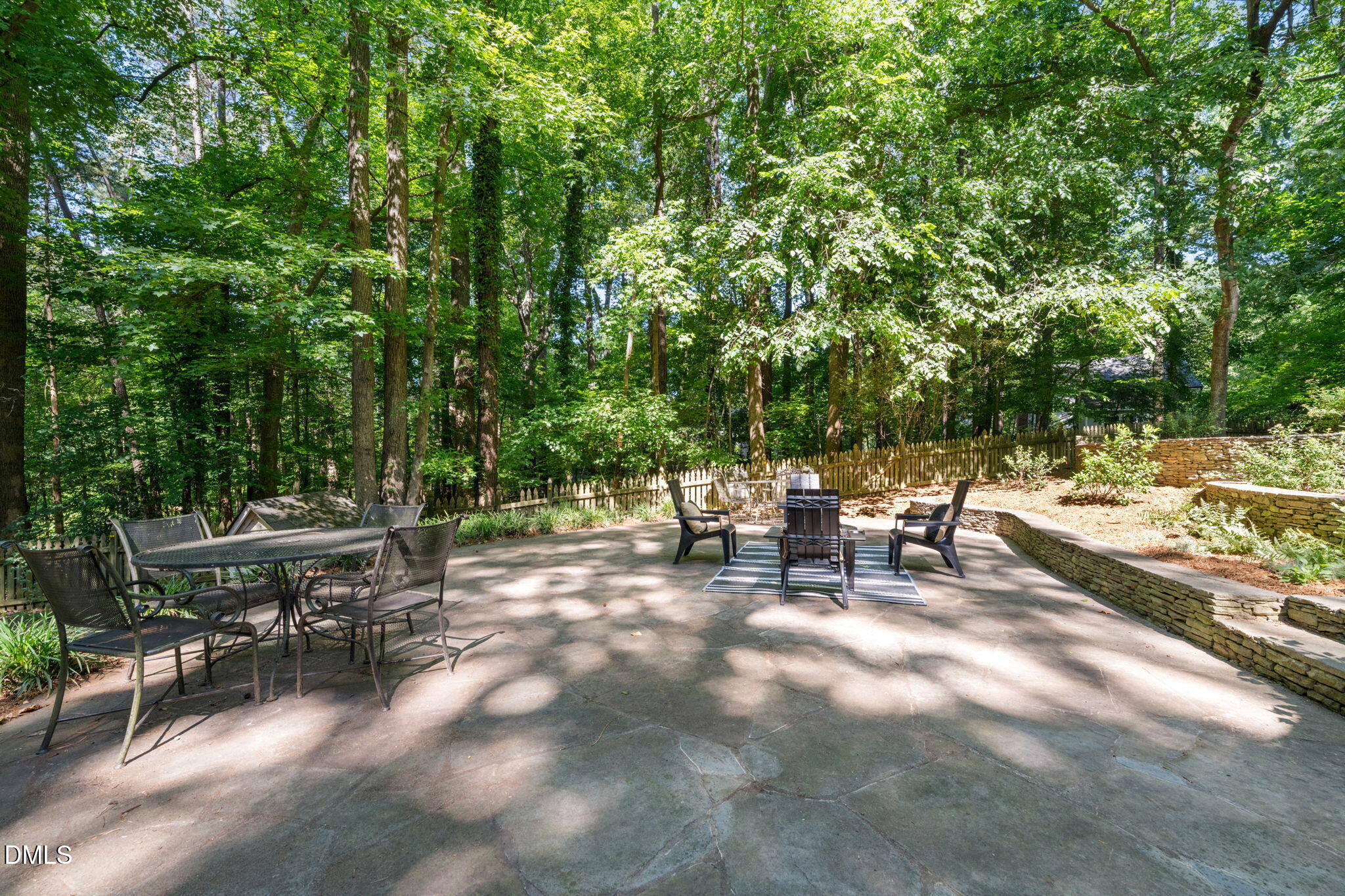 18 Strawberry Ridge Lane Durham, NC 27713 - Photo 44 of 59 a view of a patio with table and chairs and potted plants with large tree