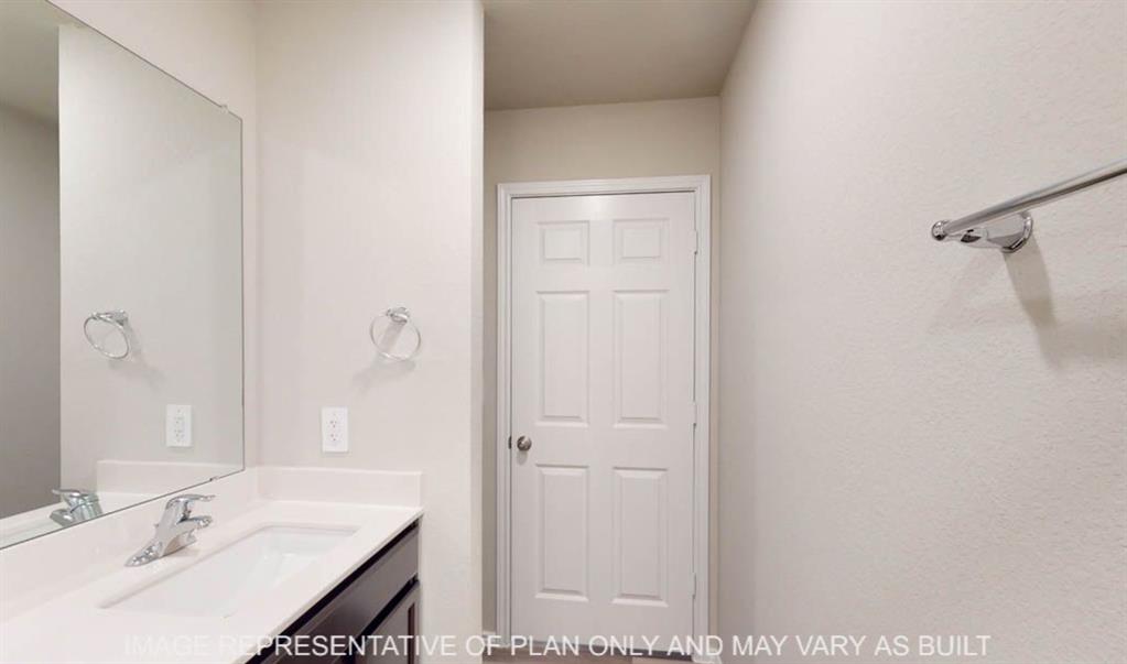 10204 Neptune Court Waco, TX 76708 - Photo 20 of 20 Bathroom vanity featuring a chrome faucet, integrated rectangular sink, and light-toned countertop