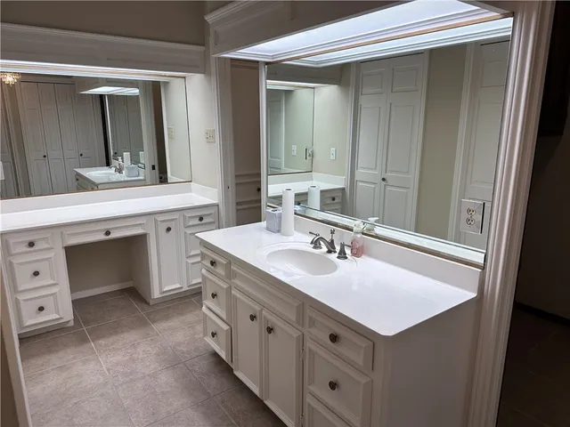 a bathroom with a sink vanity and mirror