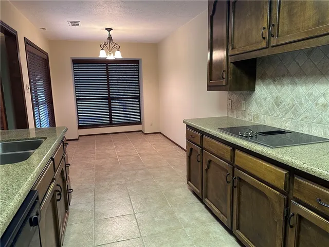 a kitchen with a sink and a mirror