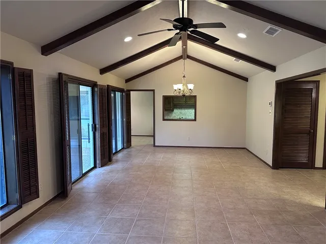 a view of an empty room with closet area